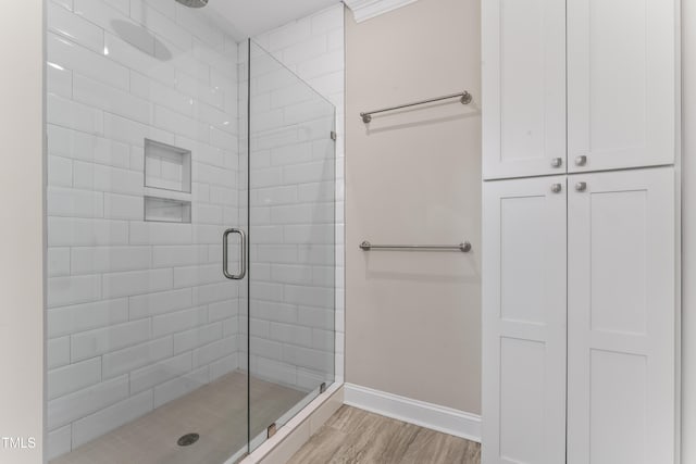 bathroom featuring hardwood / wood-style flooring and walk in shower