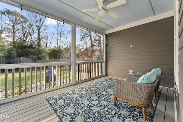 sunroom / solarium featuring ceiling fan