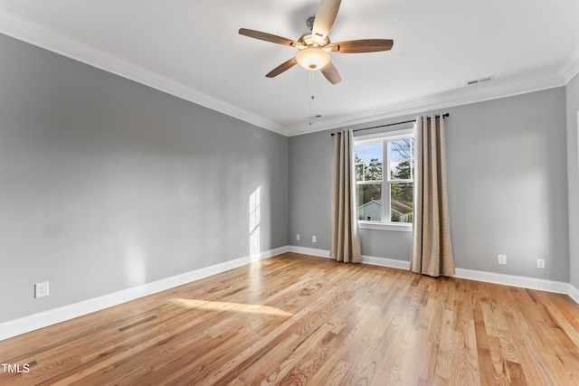 spare room featuring ceiling fan, ornamental molding, and light hardwood / wood-style floors