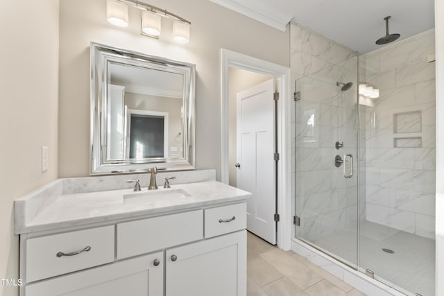 bathroom with an enclosed shower, vanity, and ornamental molding