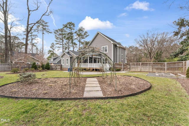 rear view of property with a yard