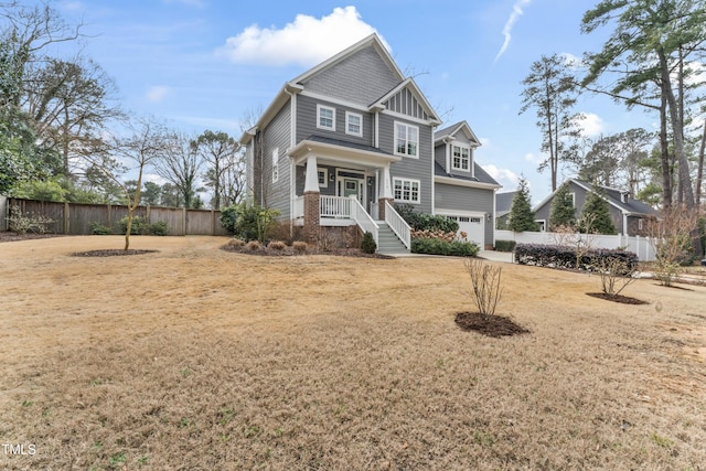 craftsman-style home featuring a garage and a front lawn