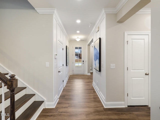 hallway featuring ornamental molding and dark hardwood / wood-style flooring