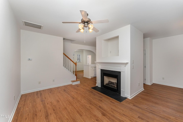 unfurnished living room with ceiling fan and light hardwood / wood-style flooring