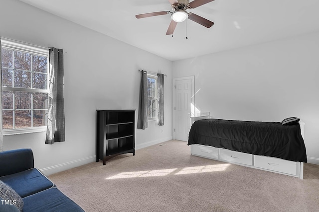 bedroom featuring ceiling fan and light colored carpet