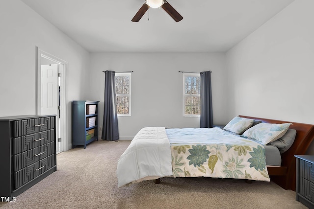 bedroom featuring light carpet and ceiling fan