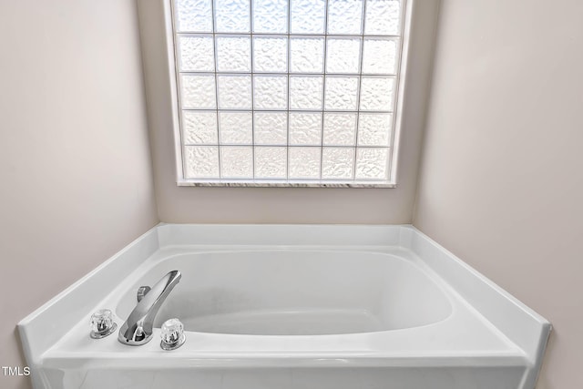 bathroom with a tub to relax in