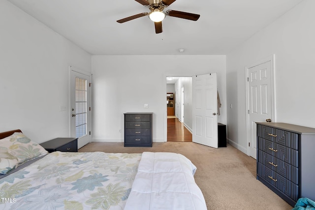 bedroom with ceiling fan and light carpet