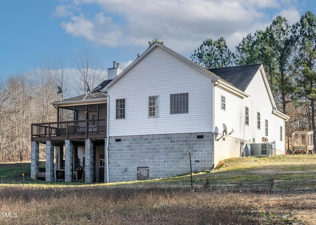 back of property featuring central AC and a wooden deck