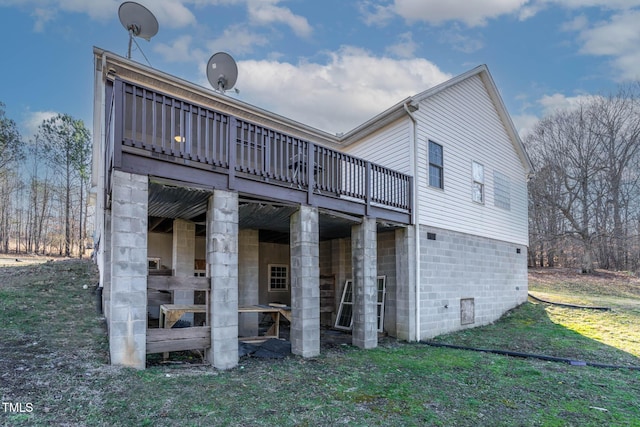 rear view of property featuring a yard and a deck