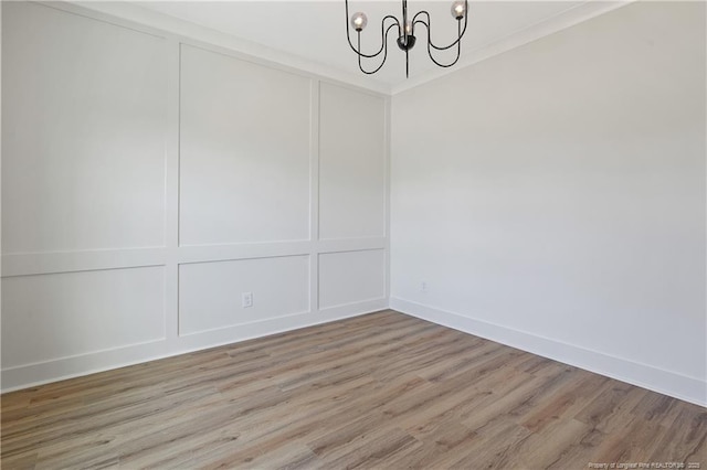 4921 High Branch Ct, Stedman, NC 28391 - unfurnished dining area featuring baseboards, ornamental molding, an inviting chandelier, a decorative wall, and light wood-style floors