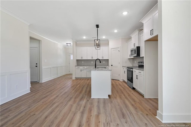 4921 High Branch Ct, Stedman, NC 28391 - kitchen featuring ornamental molding, backsplash, a center island with sink, stainless steel appliances, and white cabinets
