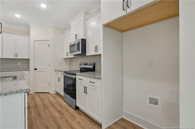 4921 High Branch Ct, Stedman, NC 28391 - kitchen featuring crown molding, tasteful backsplash, light wood-type flooring, and appliances with stainless steel finishes