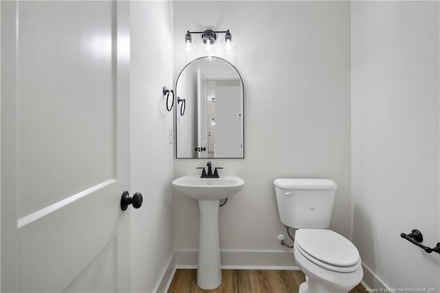 4921 High Branch Ct, Stedman, NC 28391 - half bath with baseboards, toilet, a sink, and wood finished floors