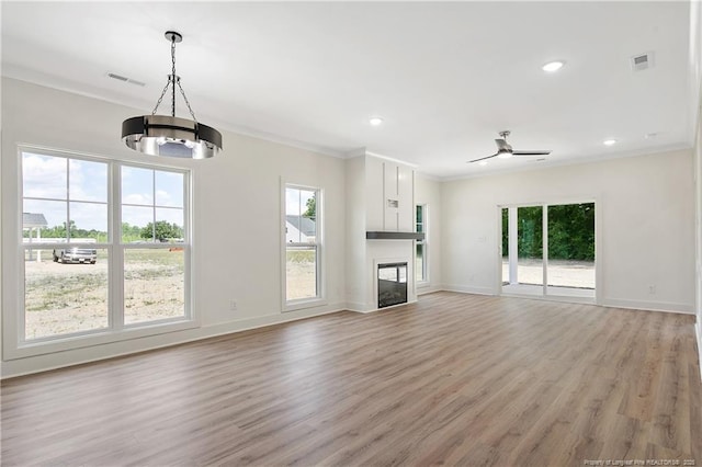 4921 High Branch Ct, Stedman, NC 28391 - unfurnished living room with light wood-type flooring, visible vents, crown molding, ceiling fan, and baseboards