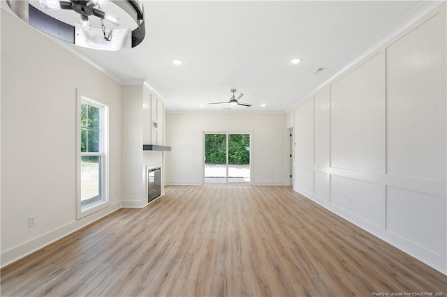 4921 High Branch Ct, Stedman, NC 28391 - unfurnished living room featuring a ceiling fan, a wealth of natural light, light wood-type flooring, and crown molding