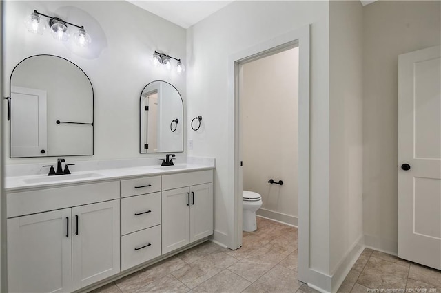 4921 High Branch Ct, Stedman, NC 28391 - bathroom featuring double vanity, toilet, baseboards, and a sink