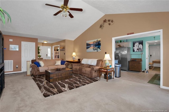 carpeted living room featuring ceiling fan and high vaulted ceiling