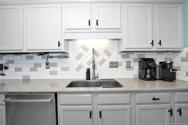 kitchen with white cabinetry, sink, decorative backsplash, and dishwasher