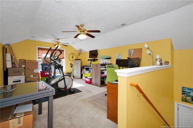 carpeted office with lofted ceiling and a textured ceiling