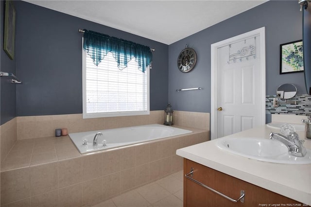 bathroom with vanity, tiled tub, and tile patterned floors