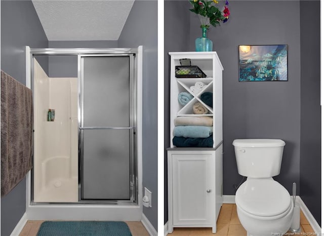 bathroom with tile patterned floors, toilet, a shower with door, and a textured ceiling