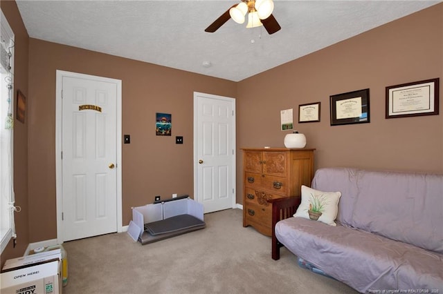 sitting room featuring light carpet and ceiling fan