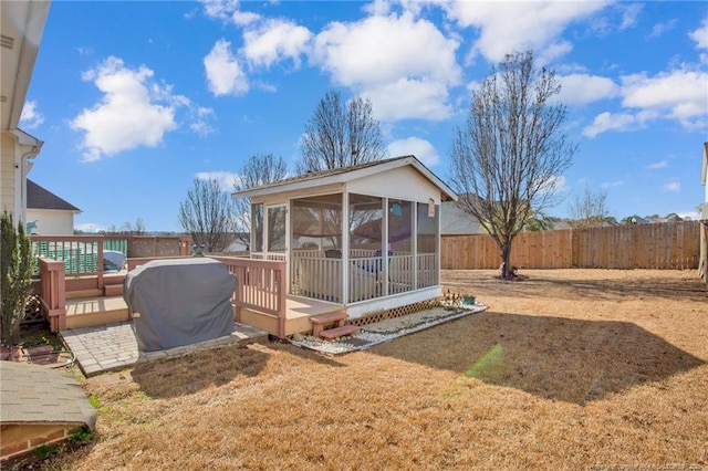 view of yard with a sunroom and a deck