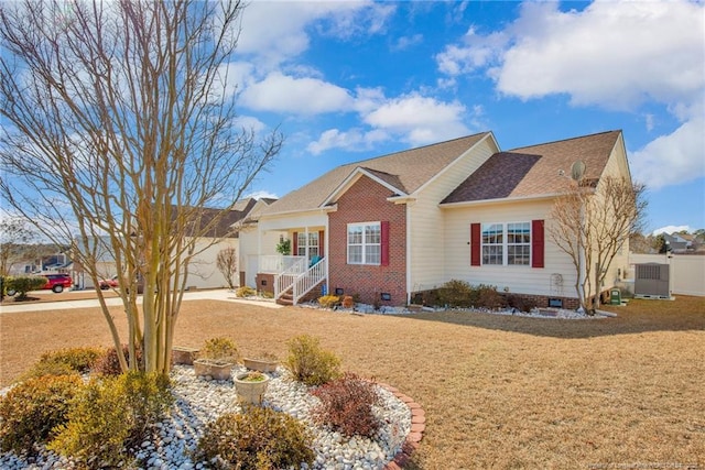 single story home with a garage, a front yard, and central air condition unit