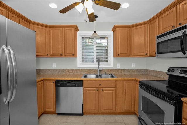 kitchen featuring sink, light tile patterned flooring, ceiling fan, and appliances with stainless steel finishes