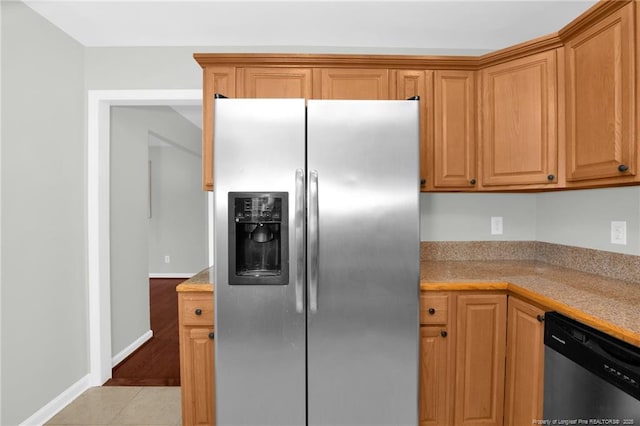 kitchen with appliances with stainless steel finishes and light tile patterned floors