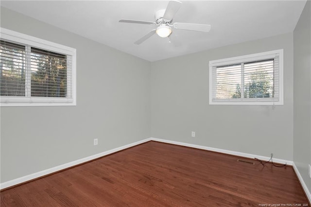 spare room featuring hardwood / wood-style floors and ceiling fan