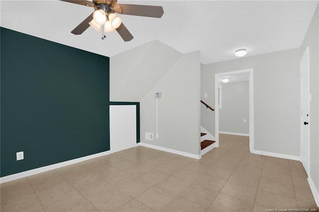 tiled spare room featuring ceiling fan