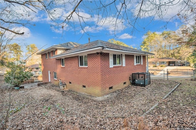 view of side of home with central air condition unit