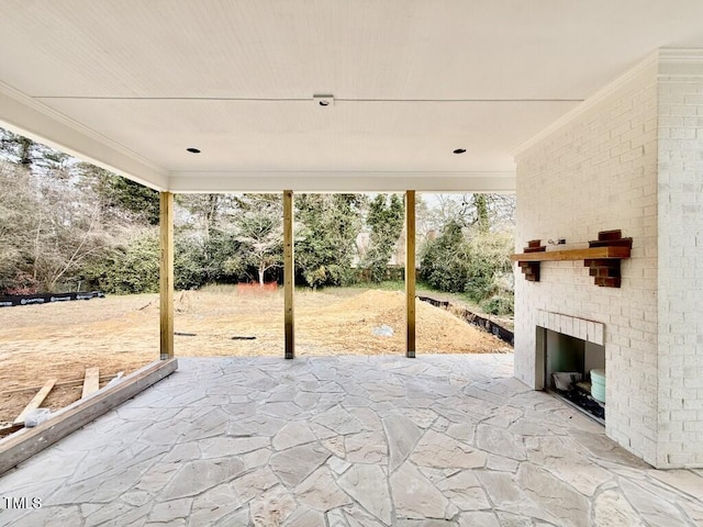 view of patio featuring an outdoor brick fireplace