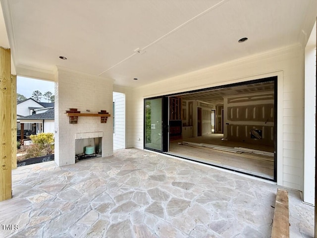 view of patio / terrace featuring an outdoor brick fireplace