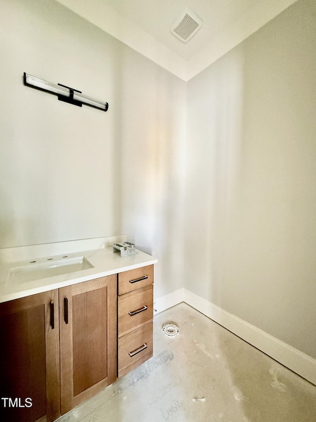 bathroom featuring visible vents, vanity, concrete flooring, and baseboards