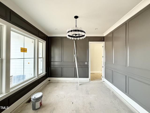 unfurnished dining area with a decorative wall, an inviting chandelier, and ornamental molding