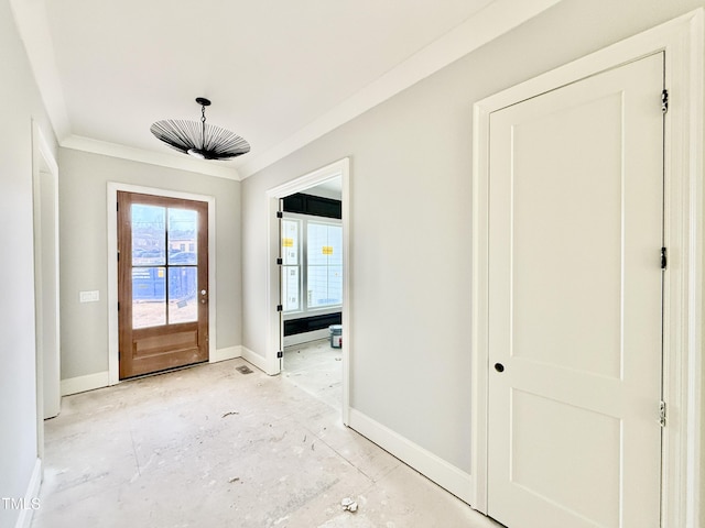 doorway to outside featuring baseboards and ornamental molding