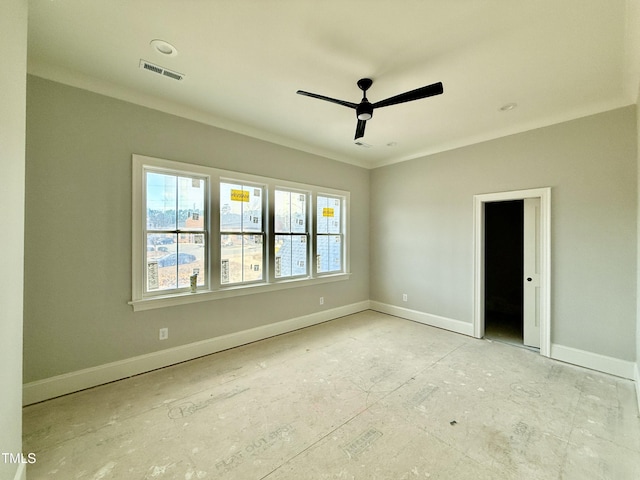 spare room with visible vents, baseboards, a ceiling fan, and crown molding