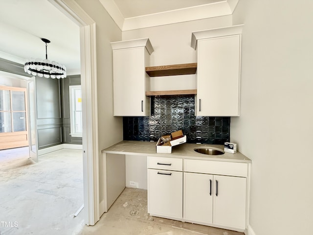 kitchen featuring decorative backsplash, white cabinetry, light countertops, and open shelves