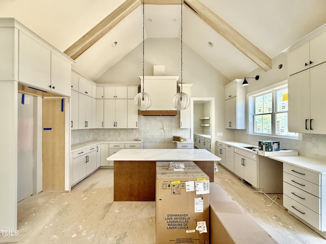 kitchen with tasteful backsplash, a kitchen island, beam ceiling, white cabinets, and high vaulted ceiling