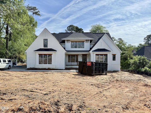 back of property with a standing seam roof, board and batten siding, and metal roof