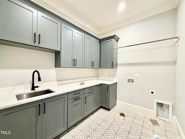 laundry room with hookup for an electric dryer, a sink, baseboards, cabinet space, and washer hookup
