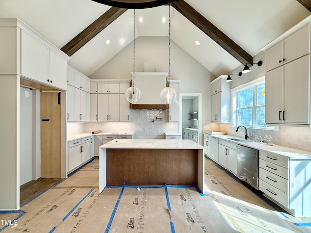 kitchen featuring high vaulted ceiling, a center island, tasteful backsplash, a sink, and dishwasher
