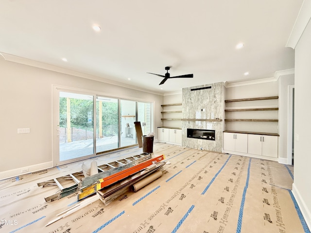 living room featuring crown molding, a high end fireplace, ceiling fan, baseboards, and recessed lighting