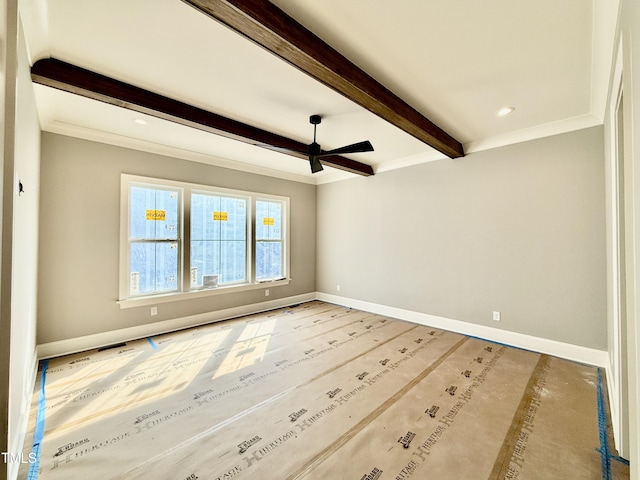 spare room featuring beam ceiling, a ceiling fan, baseboards, and visible vents