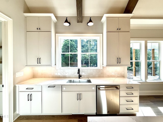5820 Shawood Dr, Raleigh, NC 27609 - kitchen with stainless steel dishwasher, a sink, beamed ceiling, tasteful backsplash, and light wood-type flooring