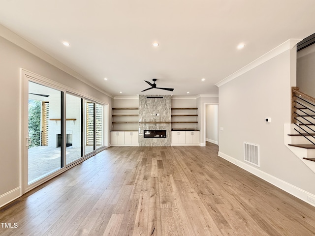 5820 Shawood Dr, Raleigh, NC 27609 - unfurnished living room with stairway, light wood-type flooring, ceiling fan, a fireplace, and baseboards