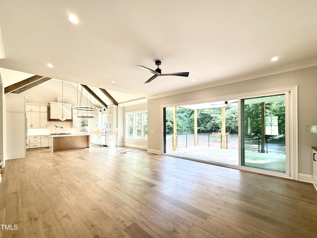 5820 Shawood Dr, Raleigh, NC 27609 - unfurnished living room with light wood finished floors, crown molding, baseboards, ceiling fan, and recessed lighting